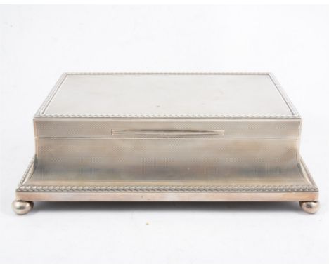 An impressive Asprey &amp; Co, cigarette/ jewel casket, engine turned with leaf design border, concave sides, all supported o