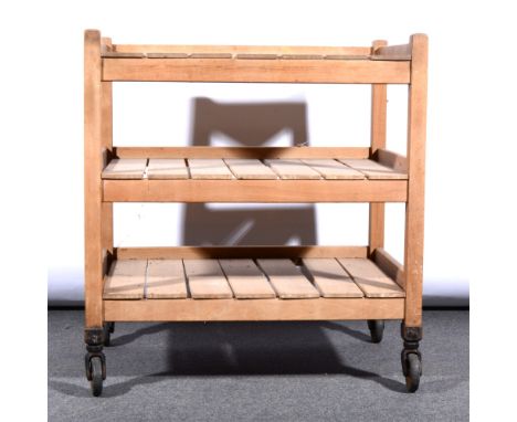 A vintage wooden three tier trolley with slatted shelves, raised on casters, width 89cm, depth 62cm, height 95cm
