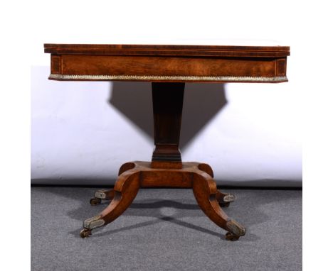 Regency rosewood pedestal card table, with a fold-over top, crossbanded outlines, cast brass mounts, tapering column, raised 