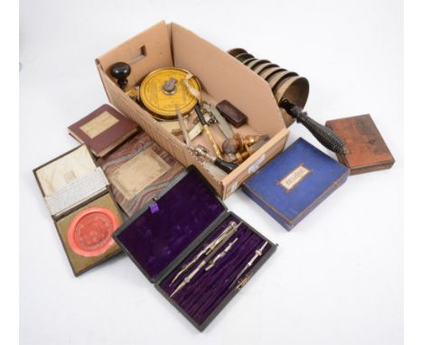 A box of assorted curios, including a bell tree with turned ebony handle, pens, and boxed games such as Besique by CG&amp;S L