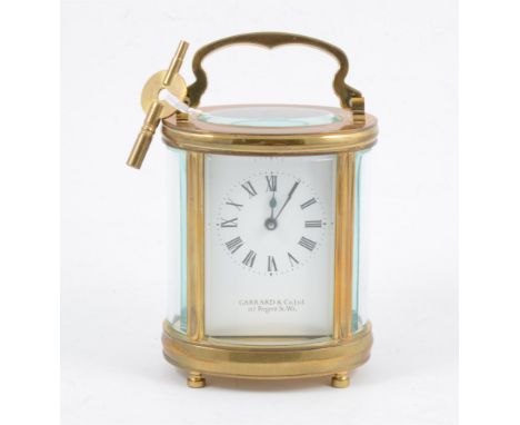 A Garrrard &amp; Co of 112 Regent St. W.1, French style brass carriage clock, oval case with oval glass panel to top revealin