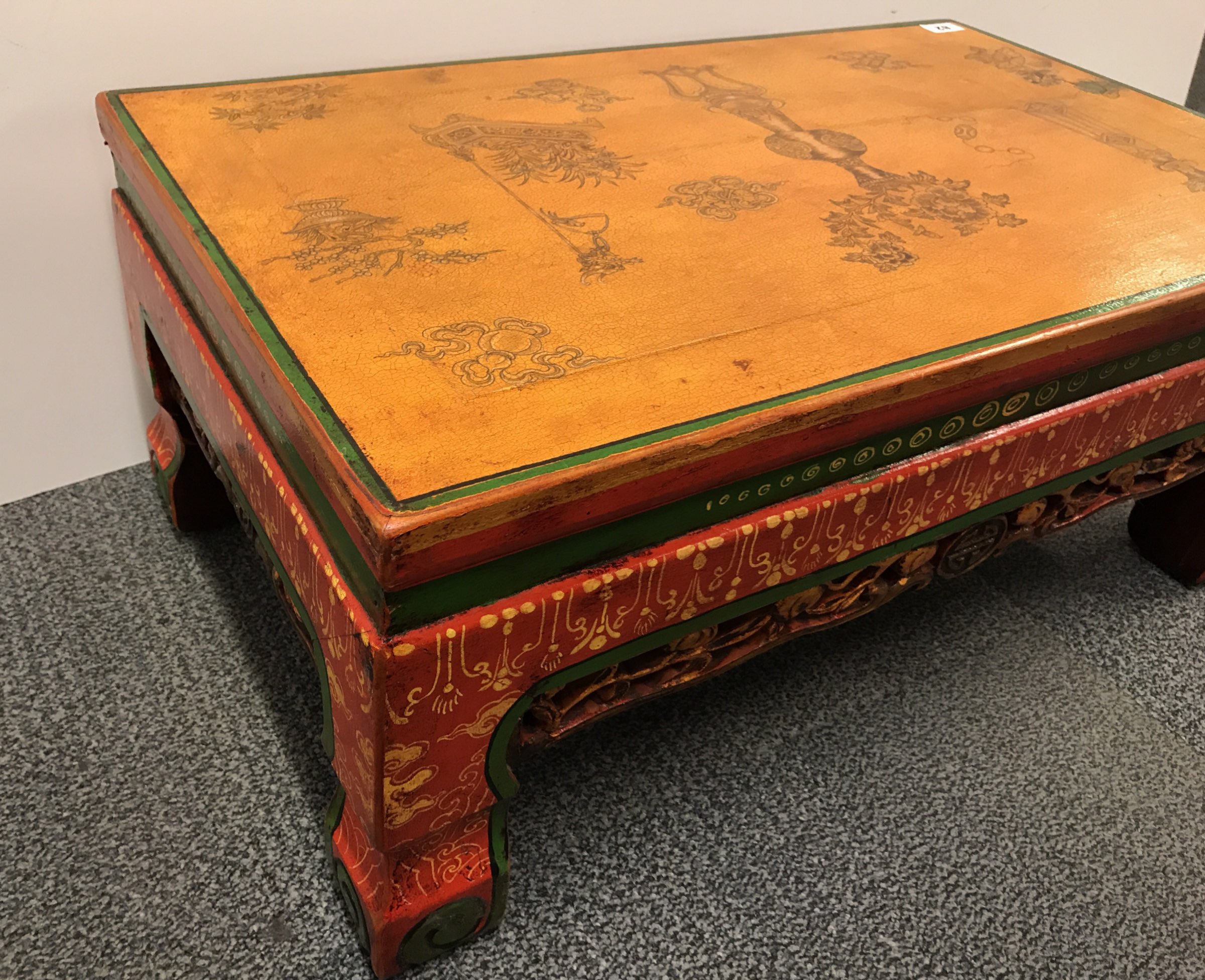 A rare Tibetan painted wooden kang table, with carved freize and ...