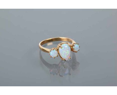 SYNTHETIC OPAL THREE STONE RING
the central pear shaped cabochon opal measuring 9.5 x 6mm, flanked by two round cabochon opal