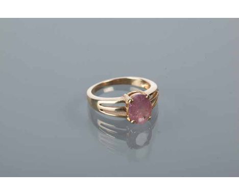 NINE CARAT RUBY RING
the oval ruby of approximately 2 carats, on trifurcated shoulders, hallmarked nine carat yellow gold, si