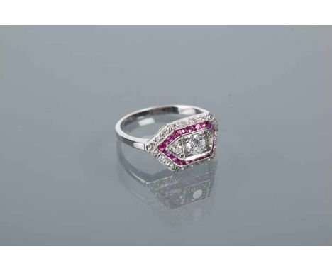 ART DECO STYLE RUBY AND DIAMOND RING
the central brilliant cut diamond approximately 0.3 carats, flanked by two smaller diamo