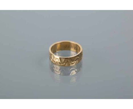 EIGHTEEN CARAT GOLD WEDDING BAND
with engraved decoration, 5.1g, size K