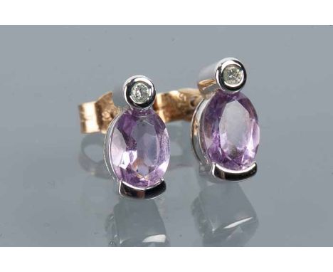 PAIR OF AMETHYST AND DIAMOND STUD EARRINGS
each with an oval amethyst and a small brilliant cut diamond, hallmarked eighteen 