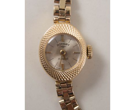 Lady's rotary wrist watch, circular silvered baton dial in a 9 carat yellow gold case with oval diamond cut bezel, fitted wit