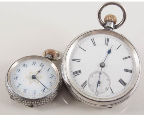Fob watch and pocket watch, open face fob watch with a white enamel arabic dial in a floral engraved white metal case stamped