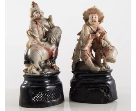 Two Chinese hardstone carvings, figures with temple lions, height 21cms and a small carved stone statue of a seated figure, (