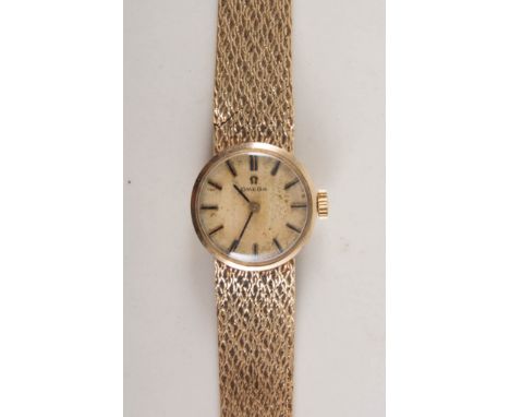 Lady's Omega wristwatch, circular champagne baton dial in a 9 carat yellow gold case with integral textured milanese bracelet