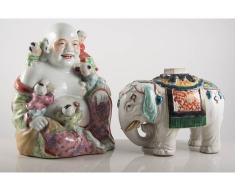 A Chinese ceramic elephant jar, lacking lid, 17cms, and two models of Buddha (3)