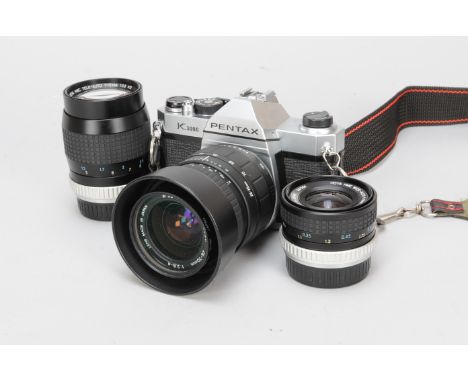 A Pentax K1000 SLR Camera and Lenses, serial no 6935805, chrome, shutter working, with Sigma UC Zoom 28-70mm f/2.8-4 lens  an