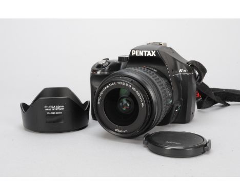 A Pentax K-M SLR Digital Camera, with 18-55mm f/3.5-5.6 AL lens, body VG, barrel VG, elements VG, with manuals, untested 