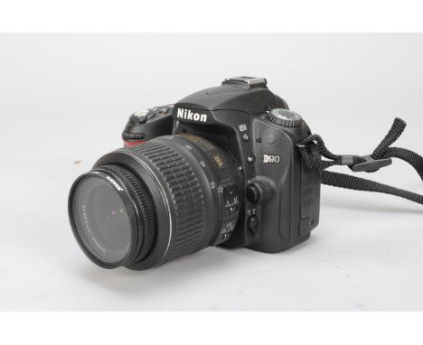 A Nikon D90 DSLR Camera, serial no 7416534, with an AF-S DX Nikkor 18-55mm f/3.5-5.6G VR lens with instructions, battery, mem