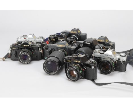 A Tray of Canon SLR Cameras, including a black A1, lens button missing, a black AE-1 , a chrome AE-1, lens front bezel missin