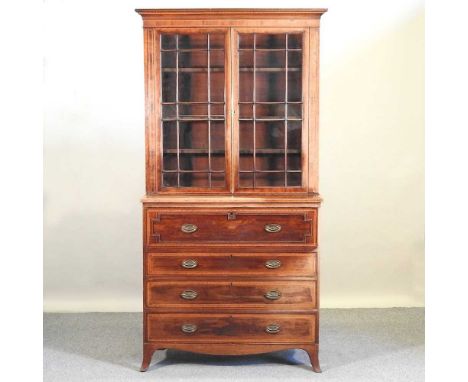 A 19th century mahogany and crossbanded secretaire bookcase, with a glazed upper section and fitted interior, on swept bracke