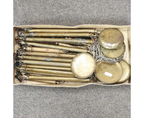 A collection of brass hand scales, each 25cm long