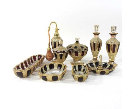 An early 20th century Bohemian overlaid glass dressing table set, with ornate gilt decoration, to include a pair of perfume b