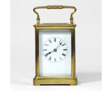 A mid 20th century brass cased carriage clock, with a white enamel dial, 14cm high