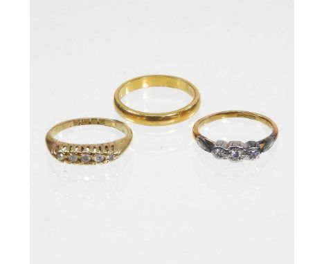 An 18 carat gold five stone diamond ring, 3.4g, size K/L, together with an 18 carat gold and platinum set three stone diamond