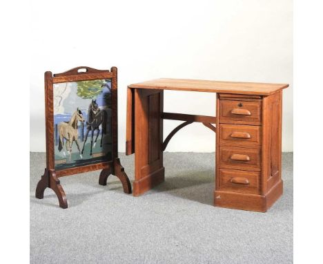 An early 20th century light oak desk, with a hinged top, together with an oak fire screen (2)84w x 44d x 166h 