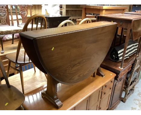 Ercol drop leaf table together with a set of four stick back chairs