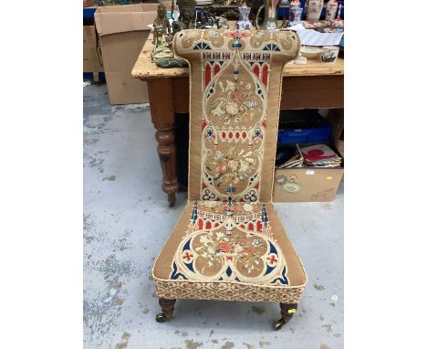 Victorian prie dieu chair with tapestry upholstery, on turned legs and brass capped castors