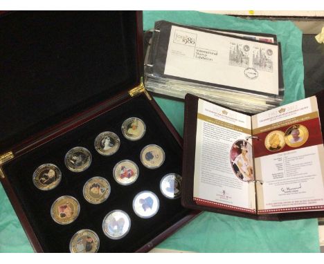 Group of commemorative coins in albums and First Day Covers