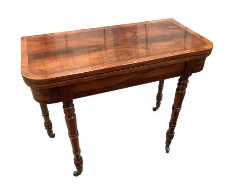 Regency rosewood and brass inlaid card table, of rounded rectangular form, green baize lined interior on ring turned legs and