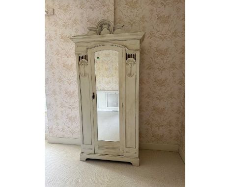Art Nouveau inspired painted wardrobe with pierced and embossed decoration and central mirror, 113cm wide, 48.5cm deep, 205cm