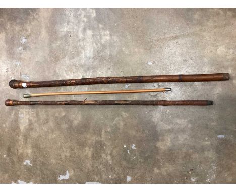 Two late 19th century Japanese carved bamboo walking sticks, one with bone inlay, together with a Royal Artillery swagger sti