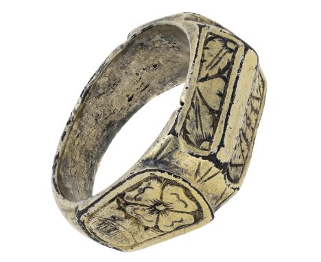 A silver gilt ring, circa 1500, the hoop of D-shaped cross section, the two longitudinal slightly concave facets divided by a