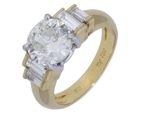 A diamond ring, the central brilliant-cut diamond claw set between duos of graduated baguette-cuts in tiered collet settings,