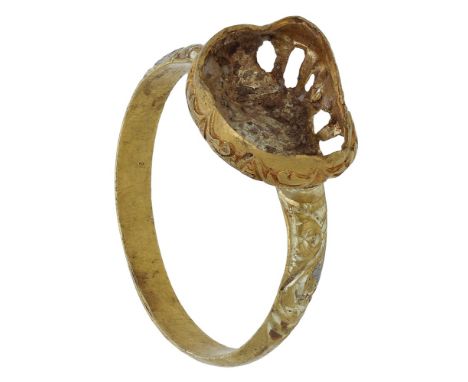 A gold ring mount, 17th century, the raised oval bezel (distorted) with vacant setting, the sides of bezel with scroll engrav