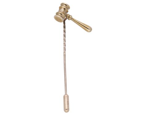 An auctioneer’s gavel stick pin, the 9ct gold gavel diagonally mounted, the pin with maker’s mark ‘MHLd’, London hallmark for