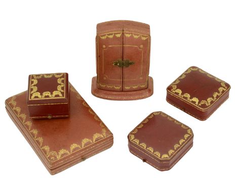 Five various empty red leather and gilt tooled Cartier cases, comprising a vertical ’armoire’ style ear pendants case, a rect