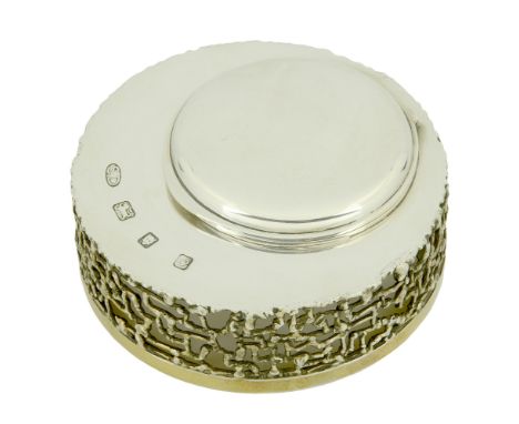 A silver and parcel gilt ink stand by Stuart Devlin, 1969, of circular form, the off-centre inkwell with hinged cover, contai
