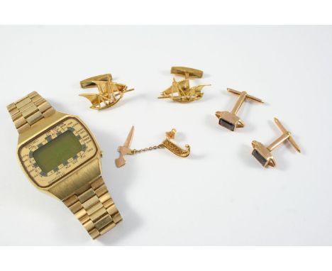 A PAIR OF GOLD GALLEON CUFFLINKS a pair of garnet and gold cufflinks, a gold tie pin, total weight 21 grams, and a stainless 