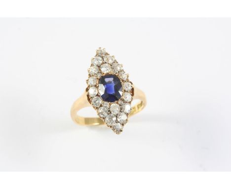 A SAPPHIRE AND DIAMOND MARQUISE-SHAPED CLUSTER RING the oval-shaped sapphire is set within a surround of graduated circular o