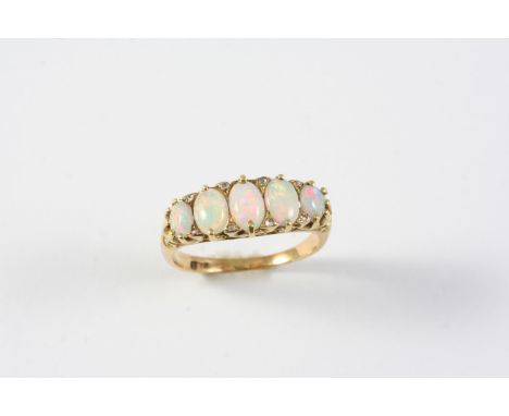 AN OPAL FIVE STONE RING the five graduated oval-shaped solid white opals are set with rose-cut diamond highlights in 18ct yel