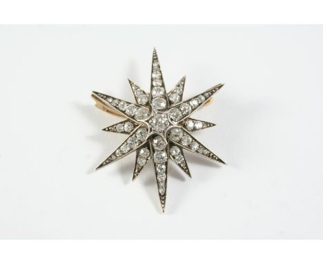 A VICTORIAN DIAMOND STAR BROOCH set overall with graduated old circular-cut and rose-cut diamonds, in silver and backed in go