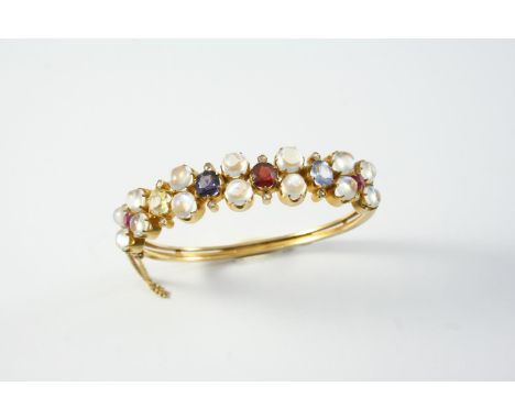 A GOLD, MOONSTONE, DIAMOND AND GEM SET HALF HINGED BANGLE mounted to one side with circular cabochon moonstones, rose-cut dia