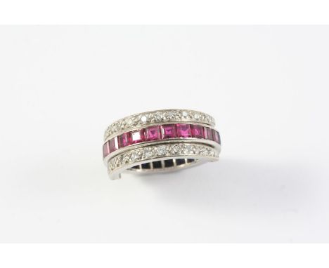 A RUBY, SAPPHIRE AND DIAMOND SWIVEL ETERNITY RING millegrain set with circular-cut diamonds and with calibre-cut sapphires an