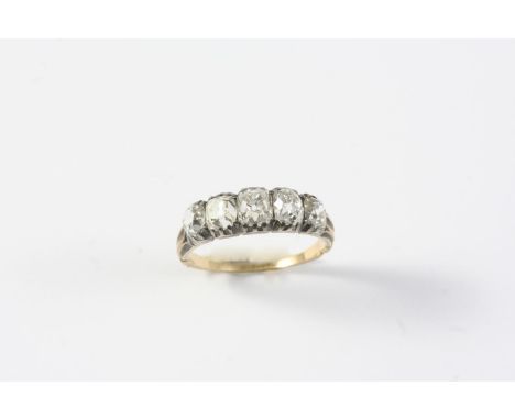 A VICTORIAN DIAMOND FIVE STONE RING mounted with five cushion-shaped diamonds, set in silver and gold. Size L 1/2