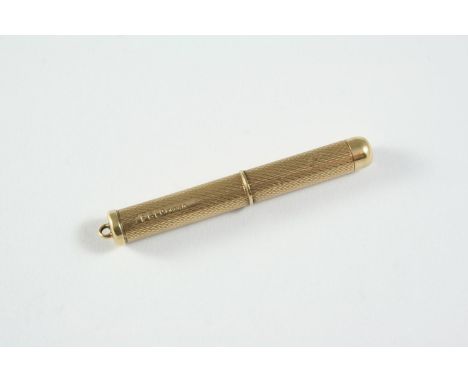 A 9CT GOLD CIGAR CUTTER engraved with engine turned decoration, hallmarked for Birmingham 1978, marker's mark P G Ltd., 6.7 g