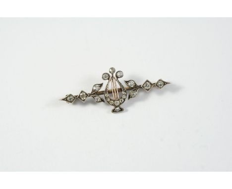 A VICTORIAN DIAMOND LYRE BROOCH set with rose-cut and old circular-cut diamonds, in silver and gold, 4.5cm wide