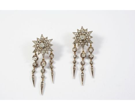 A PAIR OF VICTORIAN DIAMOND DROP EARRINGS each of star design, set with graduated old cut diamonds, suspending three diamond 