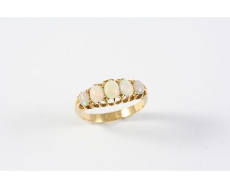 AN OPAL FIVE STONE RING set with five graduated solid white opals in 18ct yellow gold. Size N