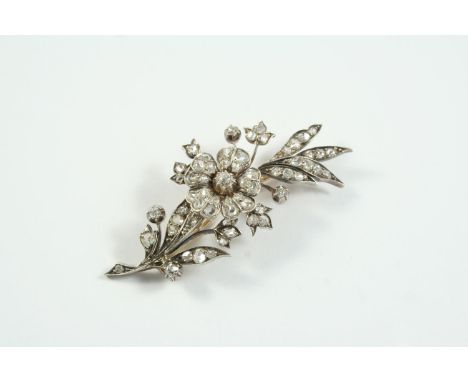 A VICTORIAN DIAMOND SPRAY BROOCH set overall with graduated old-cut and rose-cut diamonds in silver and backed in gold, 6cm l